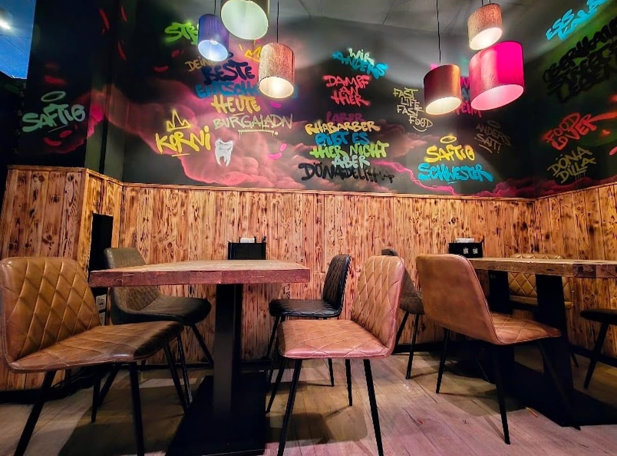 Sitzbereich mit Graffitiwand und Holzvertäfelung