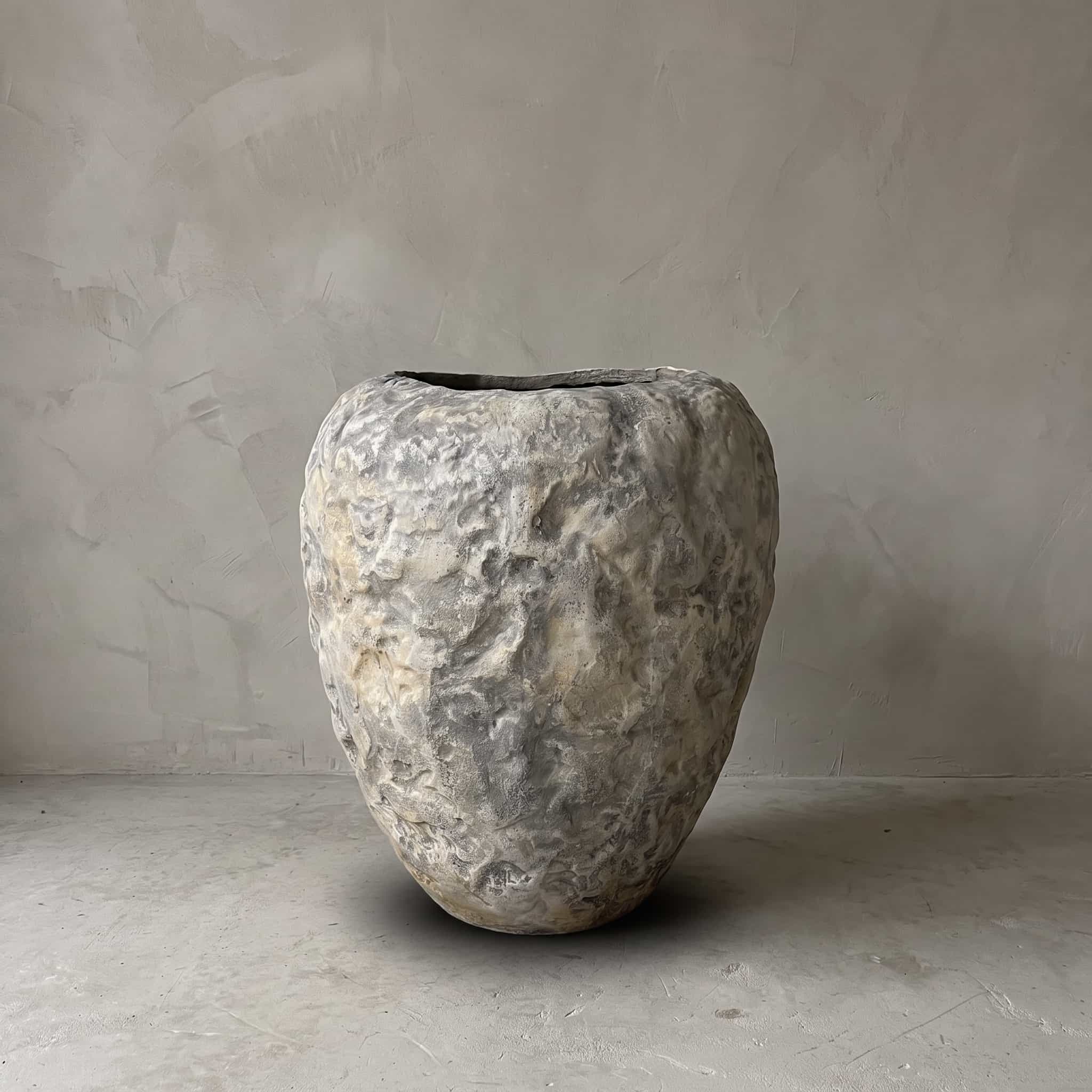 Pot van polystone, guavevorm, lichtgrijs, vooraanzicht van de pot met bobbelig oppervlak en ronde schouder voor een grijze wand