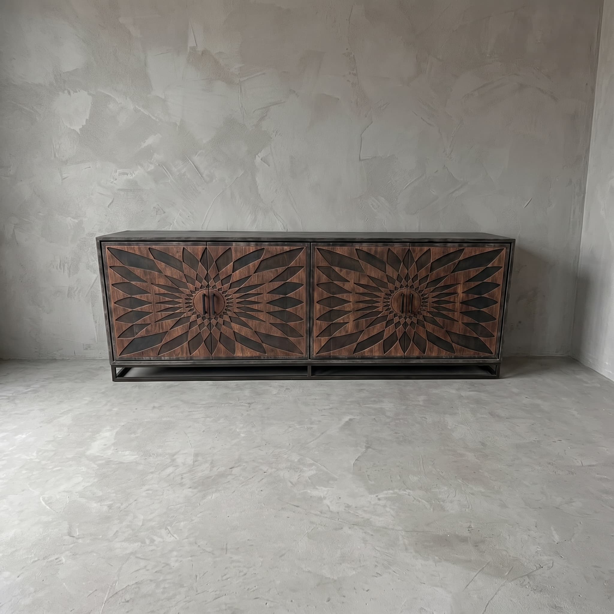 Intan teak sideboard, front view in Acak with dark finish, with two patterns of pointed leaf shapes across four doors.